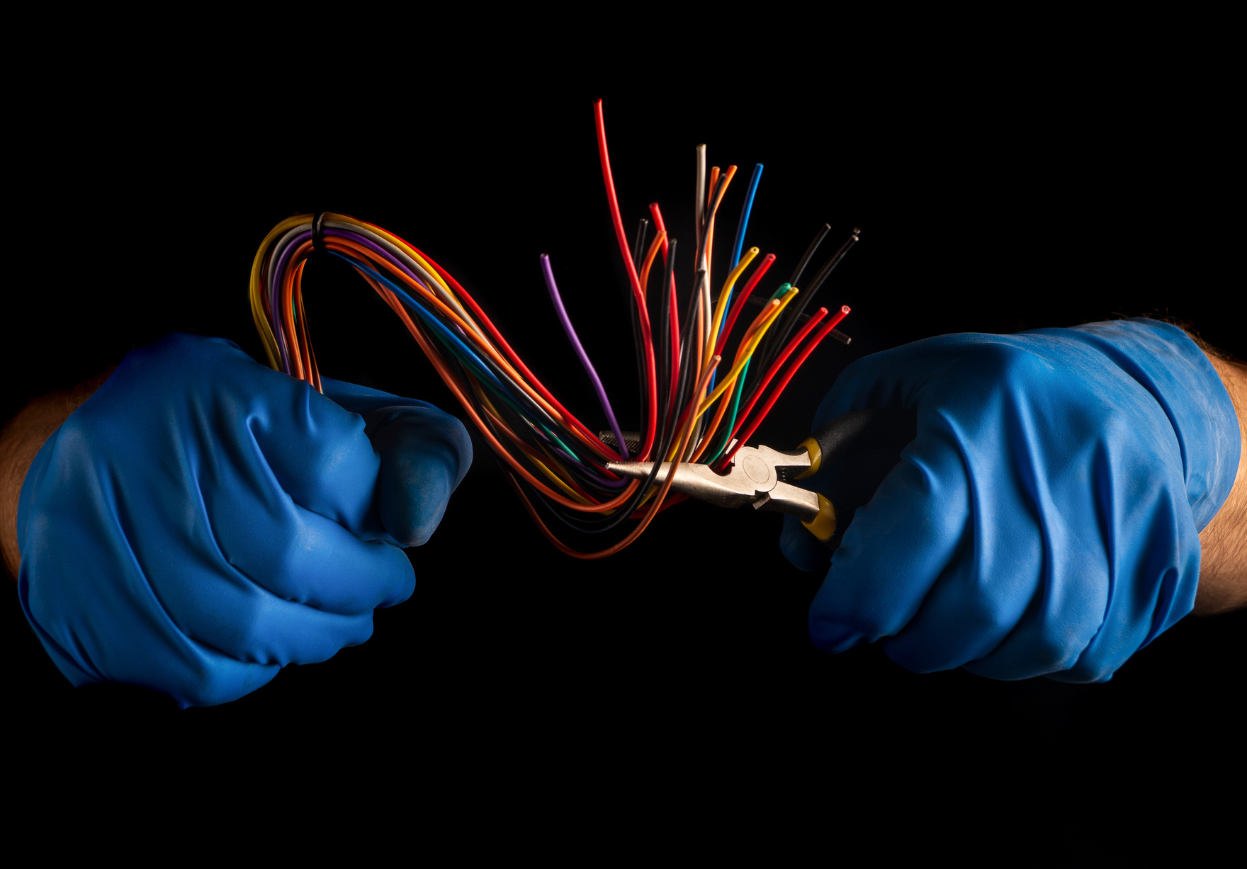 Close-up of the hands of a master electrician in gloves during w